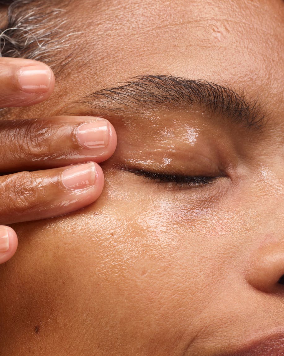 Selena massages Milky Oil onto her eye.