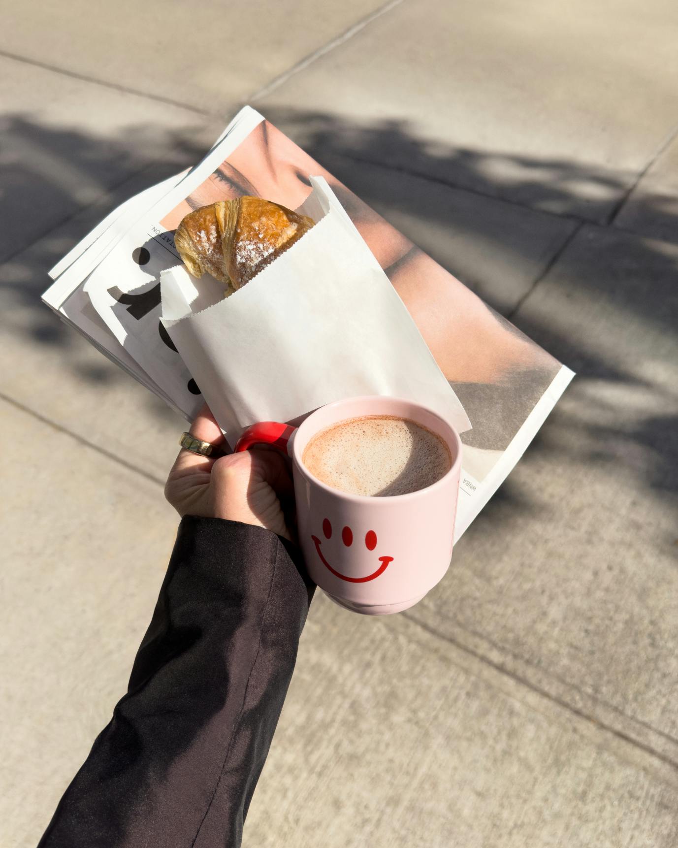 hand holding mug with coffee